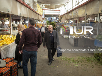 An Iranian man walks along a bazaar in the historical city of Tabriz, located 624 km (388 miles) northwest of Tehran in the Eastern Azerbaij...