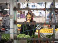 An Iranian woman looks at vegetables while shopping at a bazaar in the historical city of Tabriz, located 624 km northwest of Tehran in the...