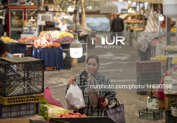 An Iranian woman shops at a bazaar in the historical city of Tabriz, located 624 km northwest of Tehran in the Eastern Azerbaijan Province,...