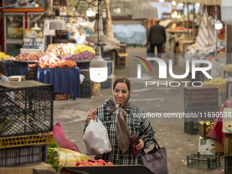 An Iranian woman shops at a bazaar in the historical city of Tabriz, located 624 km northwest of Tehran in the Eastern Azerbaijan Province,...