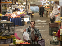 An Iranian woman shops at a bazaar in the historical city of Tabriz, located 624 km northwest of Tehran in the Eastern Azerbaijan Province,...