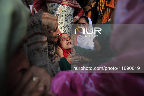 In Budgam, Kashmir, India, on October 21, 2024, a sister mourns over the dead body of Doctor Shahnawaz Ahmad Dar during his funeral ceremony...