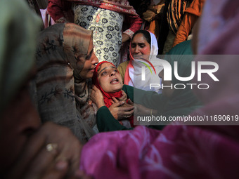 In Budgam, Kashmir, India, on October 21, 2024, a sister mourns over the dead body of Doctor Shahnawaz Ahmad Dar during his funeral ceremony...