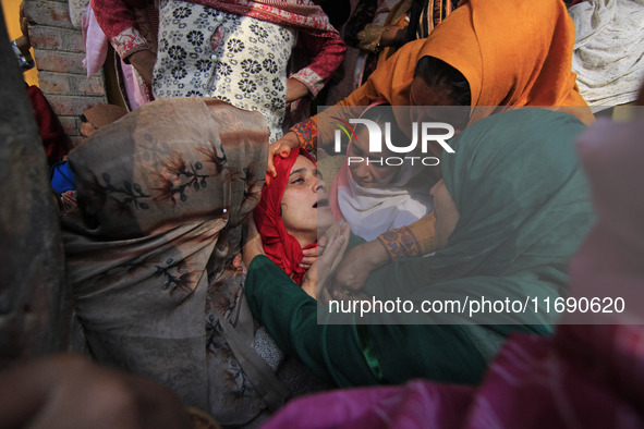 In Budgam, Kashmir, India, on October 21, 2024, a sister mourns over the dead body of Doctor Shahnawaz Ahmad Dar during his funeral ceremony...