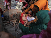 In Budgam, Kashmir, India, on October 21, 2024, a sister mourns over the dead body of Doctor Shahnawaz Ahmad Dar during his funeral ceremony...