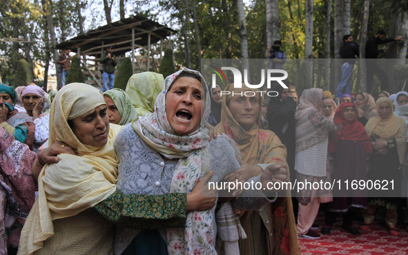 Women mourn over the body of Doctor Shahnawaz Ahmad Dar during his funeral ceremony in his native village in Nadigam in central Kashmir's Bu...