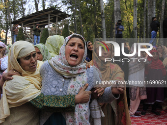 Women mourn over the body of Doctor Shahnawaz Ahmad Dar during his funeral ceremony in his native village in Nadigam in central Kashmir's Bu...