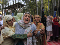 Women mourn over the body of Doctor Shahnawaz Ahmad Dar during his funeral ceremony in his native village in Nadigam in central Kashmir's Bu...