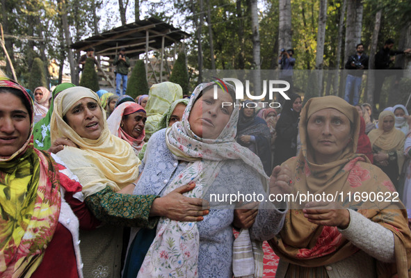 Women mourn over the body of Doctor Shahnawaz Ahmad Dar during his funeral ceremony in his native village in Nadigam in central Kashmir's Bu...