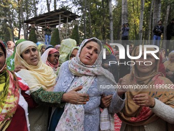 Women mourn over the body of Doctor Shahnawaz Ahmad Dar during his funeral ceremony in his native village in Nadigam in central Kashmir's Bu...