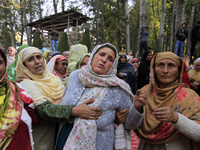 Women mourn over the body of Doctor Shahnawaz Ahmad Dar during his funeral ceremony in his native village in Nadigam in central Kashmir's Bu...