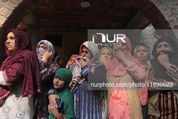 Women mourn over the body of Doctor Shahnawaz Ahmad Dar during his funeral ceremony in his native village in Nadigam in central Kashmir's Bu...