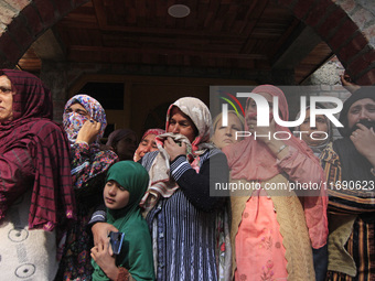 Women mourn over the body of Doctor Shahnawaz Ahmad Dar during his funeral ceremony in his native village in Nadigam in central Kashmir's Bu...