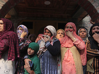 Women mourn over the body of Doctor Shahnawaz Ahmad Dar during his funeral ceremony in his native village in Nadigam in central Kashmir's Bu...