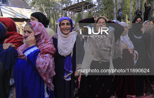 Women wail over the dead body of Doctor Shahnawaz Ahmad Dar during his funeral ceremony at his native village in Nadigam in central Kashmir'...