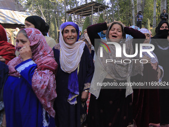 Women wail over the dead body of Doctor Shahnawaz Ahmad Dar during his funeral ceremony at his native village in Nadigam in central Kashmir'...