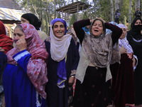 Women wail over the dead body of Doctor Shahnawaz Ahmad Dar during his funeral ceremony at his native village in Nadigam in central Kashmir'...