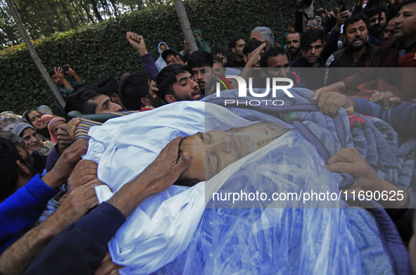 People carry the dead body of Doctor Shahnawaz Ahmad Dar during his funeral ceremony at his native village in Nadigam in central Kashmir's B...