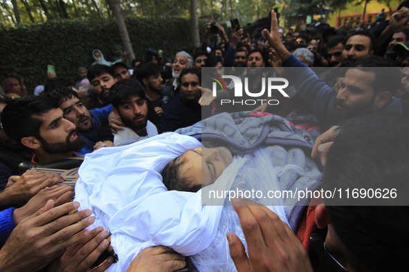 People carry the dead body of Doctor Shahnawaz Ahmad Dar during his funeral ceremony at his native village in Nadigam in central Kashmir's B...