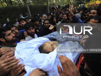 People carry the dead body of Doctor Shahnawaz Ahmad Dar during his funeral ceremony at his native village in Nadigam in central Kashmir's B...