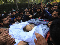 People carry the dead body of Doctor Shahnawaz Ahmad Dar during his funeral ceremony at his native village in Nadigam in central Kashmir's B...