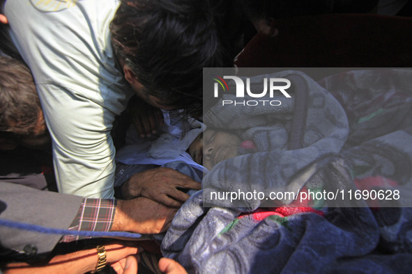 People wail over the dead body of Doctor Shahnawaz Ahmad Dar during his funeral ceremony at his native village in Nadigam in central Kashmir...