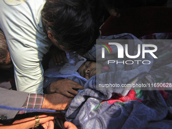 People wail over the dead body of Doctor Shahnawaz Ahmad Dar during his funeral ceremony at his native village in Nadigam in central Kashmir...