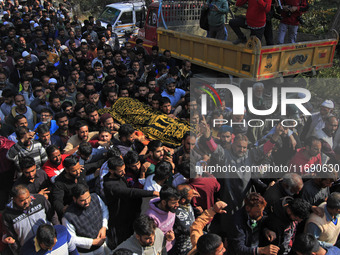 People carry the dead body of Doctor Shahnawaz Ahmad Dar during his funeral ceremony at his native village in Nadigam in central Kashmir's B...