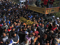 People carry the dead body of Doctor Shahnawaz Ahmad Dar during his funeral ceremony at his native village in Nadigam in central Kashmir's B...