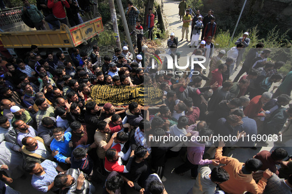 People carry the dead body of Doctor Shahnawaz Ahmad Dar during his funeral ceremony at his native village in Nadigam in central Kashmir's B...