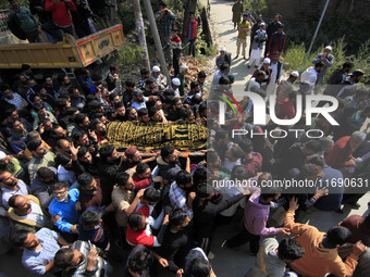 People carry the dead body of Doctor Shahnawaz Ahmad Dar during his funeral ceremony at his native village in Nadigam in central Kashmir's B...