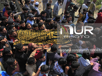 People carry the dead body of Doctor Shahnawaz Ahmad Dar during his funeral ceremony at his native village in Nadigam in central Kashmir's B...