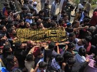 People carry the dead body of Doctor Shahnawaz Ahmad Dar during his funeral ceremony at his native village in Nadigam in central Kashmir's B...