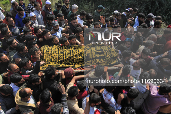 People carry the dead body of Doctor Shahnawaz Ahmad Dar during his funeral ceremony at his native village in Nadigam in central Kashmir's B...