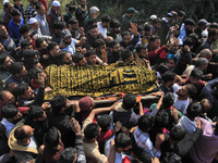 People carry the dead body of Doctor Shahnawaz Ahmad Dar during his funeral ceremony at his native village in Nadigam in central Kashmir's B...