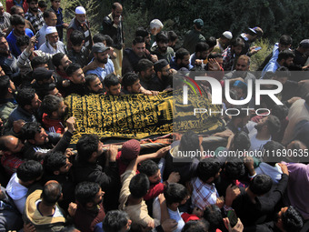 People carry the dead body of Doctor Shahnawaz Ahmad Dar during his funeral ceremony at his native village in Nadigam in central Kashmir's B...