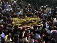 People carry the dead body of Doctor Shahnawaz Ahmad Dar during his funeral ceremony at his native village in Nadigam in central Kashmir's B...