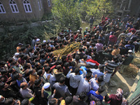 People carry the dead body of Doctor Shahnawaz Ahmad Dar during his funeral ceremony at his native village in Nadigam in central Kashmir's B...