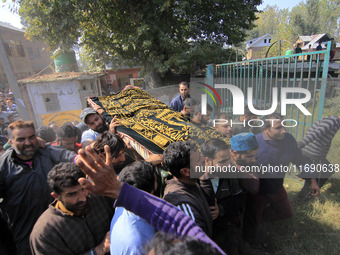 People carry the dead body of Doctor Shahnawaz Ahmad Dar during his funeral ceremony at his native village in Nadigam in central Kashmir's B...