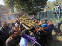 People carry the dead body of Doctor Shahnawaz Ahmad Dar during his funeral ceremony at his native village in Nadigam in central Kashmir's B...