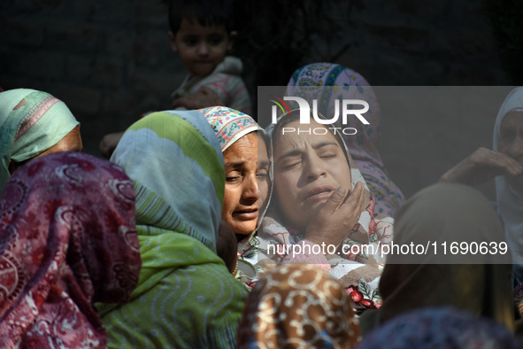 Relatives mourn over the body of Doctor Shahnawaz Ahmad Dar during his funeral ceremony at his native village in Nadigam in central Kashmir'...