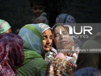 Relatives mourn over the body of Doctor Shahnawaz Ahmad Dar during his funeral ceremony at his native village in Nadigam in central Kashmir'...