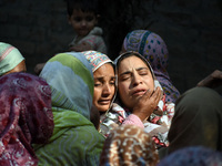 Relatives mourn over the body of Doctor Shahnawaz Ahmad Dar during his funeral ceremony at his native village in Nadigam in central Kashmir'...