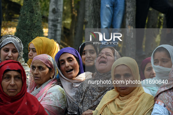 Relatives mourn over the body of Doctor Shahnawaz Ahmad Dar during his funeral ceremony at his native village in Nadigam in central Kashmir'...