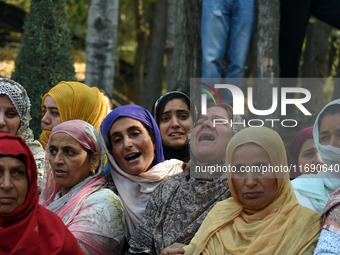 Relatives mourn over the body of Doctor Shahnawaz Ahmad Dar during his funeral ceremony at his native village in Nadigam in central Kashmir'...