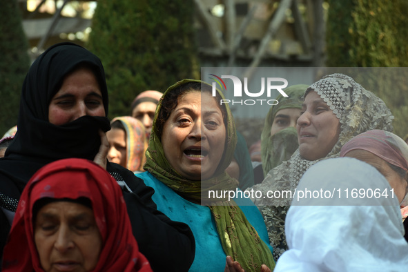 Relatives mourn over the body of Doctor Shahnawaz Ahmad Dar during his funeral ceremony at his native village in Nadigam in central Kashmir'...