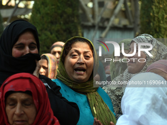 Relatives mourn over the body of Doctor Shahnawaz Ahmad Dar during his funeral ceremony at his native village in Nadigam in central Kashmir'...