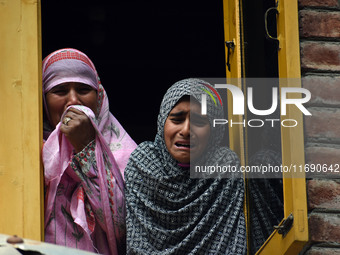 Relatives mourn over the body of Doctor Shahnawaz Ahmad Dar during his funeral ceremony at his native village in Nadigam in central Kashmir'...