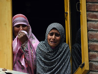 Relatives mourn over the body of Doctor Shahnawaz Ahmad Dar during his funeral ceremony at his native village in Nadigam in central Kashmir'...