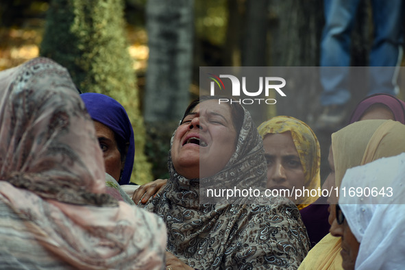 Women mourn over the body of Doctor Shahnawaz Ahmad Dar during his funeral ceremony in his native village in Nadigam in central Kashmir's Bu...